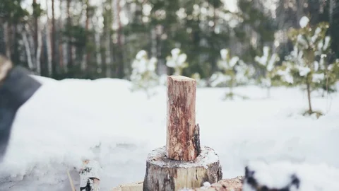 Man in self-isolation. A man cuts wood with an axe in winter. Remote work. Enjoy Stock-Footage 128453780