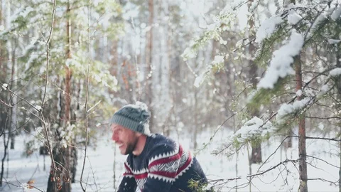 Man in self-isolation. Man play with snow in the forest. Relaxing aftter hard Stock Footage 128453888
