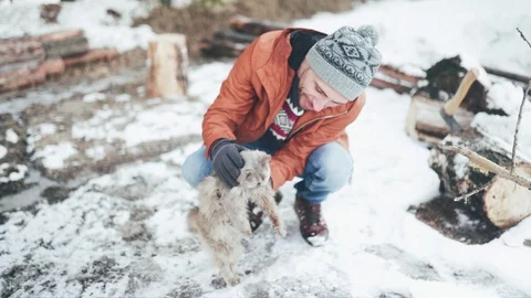Man in self-isolation. A man is sitting in the yard of a country house and Video stock 128454031