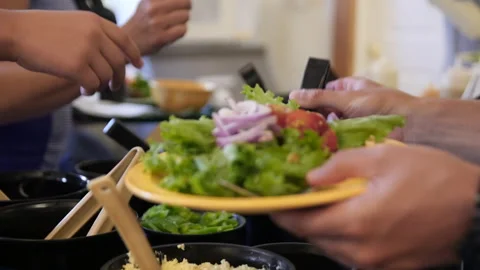 Man Self Serving Salad on a Plate Stock Footage 302557933