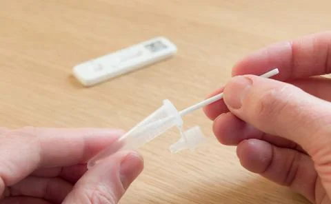 Man self-testing for Covid-19 with LFT test, UK Stock Photos