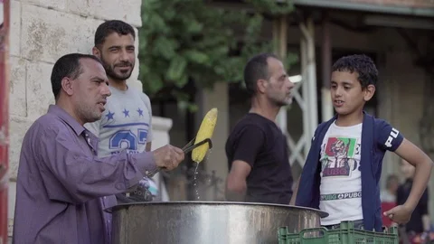 A man selling boiled corn on the side of the road in Bloudan, Syria Stock Footage 121808458