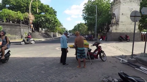 Man Sells Corn at Entrance, Split Gate, Kuta beach, Bali, Indonesia Stock Footage 303228342
