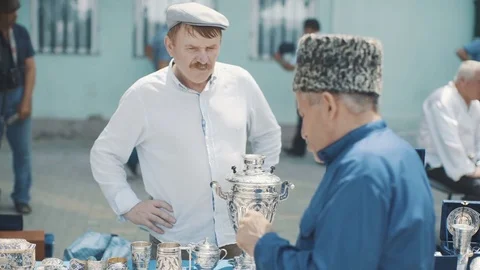 Man sells silver dishes in the eastern market. Dagestan vintage antique Stock Footage 82621294
