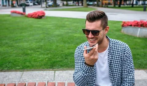 Man sending audio message with mobile Stock Photos