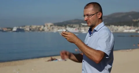 Man Sending Message Mobile Phone Typing Coast Beach Ocean View a Season Vacation Stock Footage 75846570