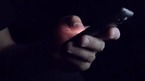 Man sending SMS text message in dark room Stock Footage 52554219