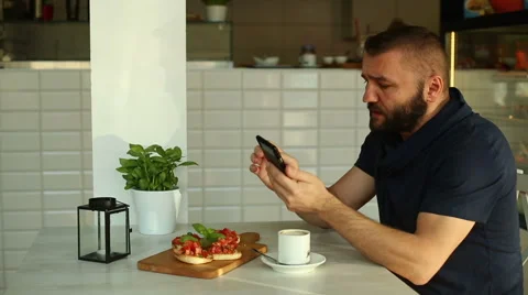 Man sending text message in restaurant Stock Footage 67992332