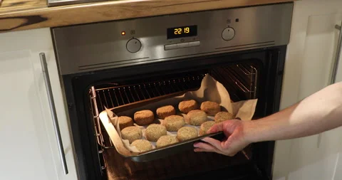 A man sends fish cakes to the oven Stock Footage 243775142
