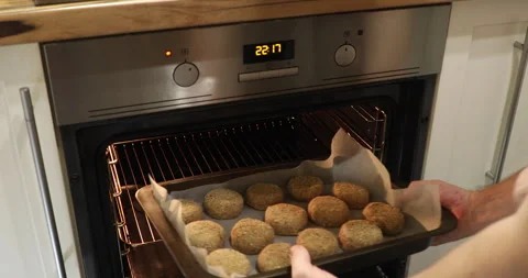 A man sends fish cakes to the oven Stock Footage 243775175