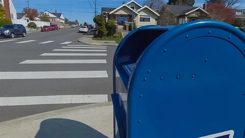 Man sends letter in public mailbox on the sidewalk. Stock Footage