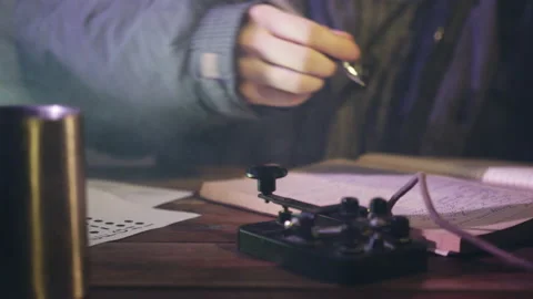 Man sends signal in Morse code writing notes in notebook Stock Footage 231218843