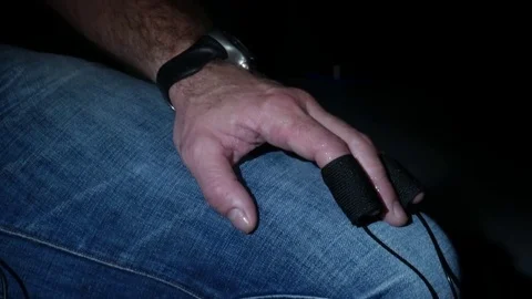 Man with sensors on finger bouncing leg 動画素材 81373461