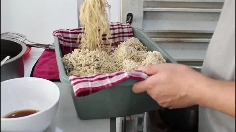 A man separate the noodle strands before boiling noodle so they don't clump Vídeo Stock 338028418