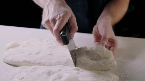 Man separating pizza dough with sharp blade Stock Footage 132803969