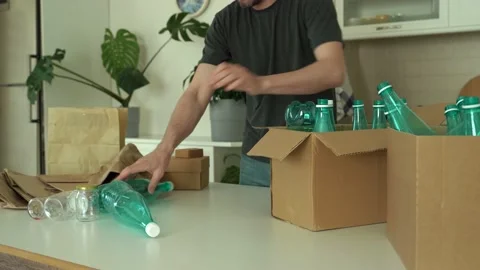 Man is separating trash and sort waste in garbage box for recycling at home Stock Footage 196606558