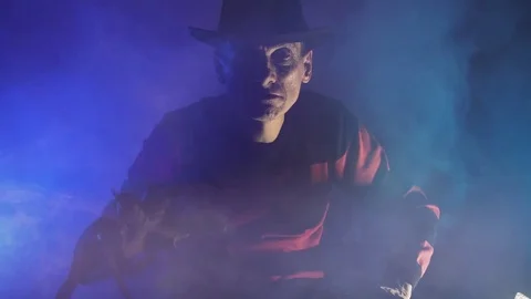 Man is a serial killer with a glove sharp knives background for Halloween Vídeos de archivo 81045481