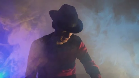 Man is a serial killer with a glove sharp knives background for Halloween Video stock 81045492