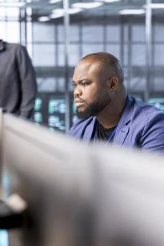 Man in server farm fixing insufficient memory errors slowing down hardware Stock Photos