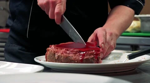 Man serves a cake on plate - close up hands Stock-Footage 65999434