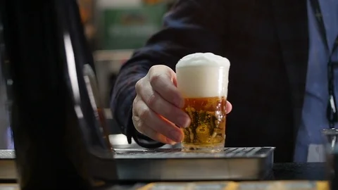 A man serves a draft beer Stock Footage 119598881