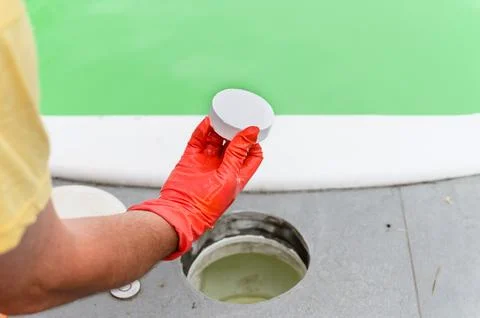A man serves the pool, replacing the tablet. Stock Photos