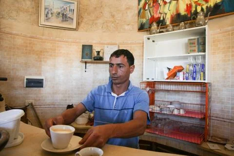 Man serving coffee at Dar Ayed Stock Photos