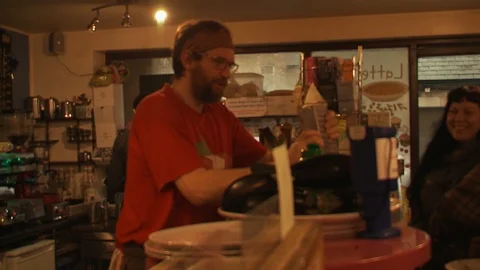 Man serving a customer at a cafe counter Stock Footage 112728654