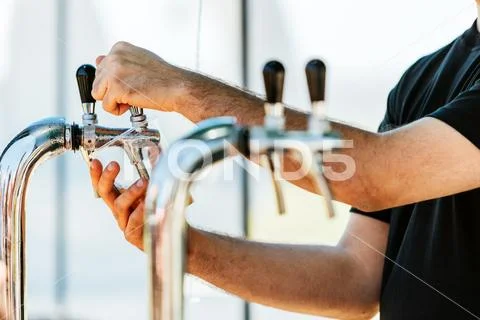 Man serving draft beer in a disposable cup Stock Photos