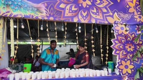 A man is serving drinks at a Panthal counte 스톡 동영상 318092848