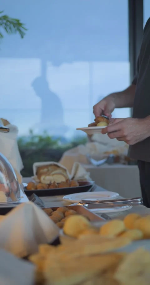A man is serving food at a buffet table Stock Footage 329972196