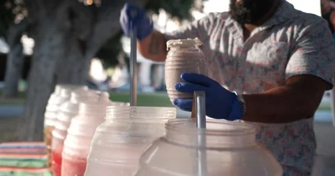 Man serving horchata drink into plastic bottle Stock Footage 297842052