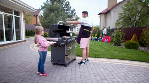 Man serving hot dogs to young women Stock Footage 130066001