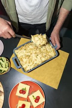 Man serving pasta with a spoon Stock Photos