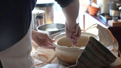 A man serving rice cooked in an earthenware pot. Stock Footage 331926390