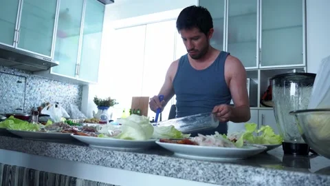 A man serving several plates of ceviche in the kitchen of a beach house with Stock Footage 178459225