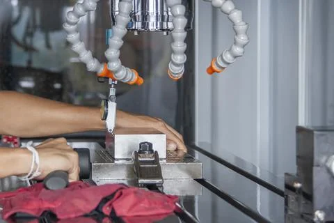 Man set up dial gauge for setting balance work   after cutting of CNC Stock Photos