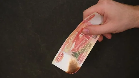 The man set fire to a 5000-ruble banknote. Crisis. Hands and burnning russian Stock Footage 242298780