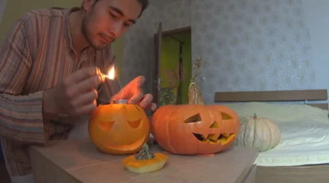 Man set fire pumpkin for Helloween Stock Footage 68627671