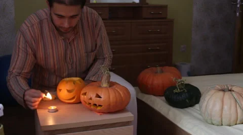 Man set fire pumpkin for Helloween Stock Footage 68628241