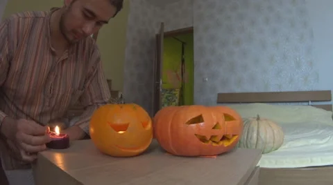 Man set fire pumpkin for Helloween Stock Footage 68659054