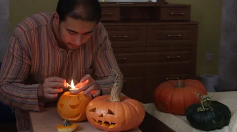 Man set fire pumpkin for Helloween Stock Footage 68659596