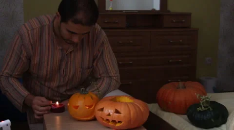 Man set fire pumpkin for Helloween Stock Footage 68685495