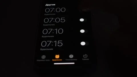 The man sets the alarm clock for the morning. the man sets the alarm clock Stock Footage 194577467