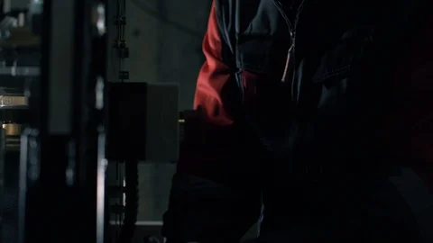 Man sets up automatic cable cutting machine.  Complex for cable cutting. Stock Footage 105529255