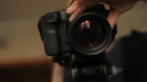 Man sets up camera Stock Footage 59134376