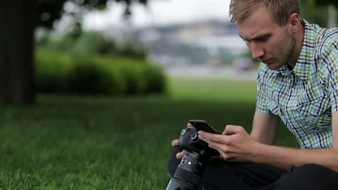 Man sets the camera before taking a picture with your smartphone Stock Footage 70681433