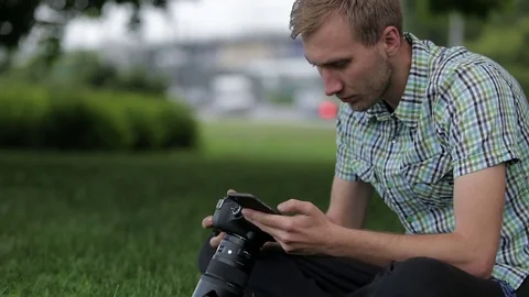 Man sets the camera before taking a picture with your smartphone Stock Footage 70681456