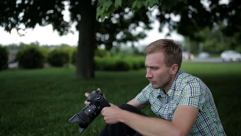 Man sets the camera before taking a picture  Stock Footage 70681471