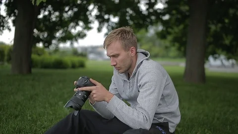 Man sets the camera before taking a picture  Stock Footage 70681484